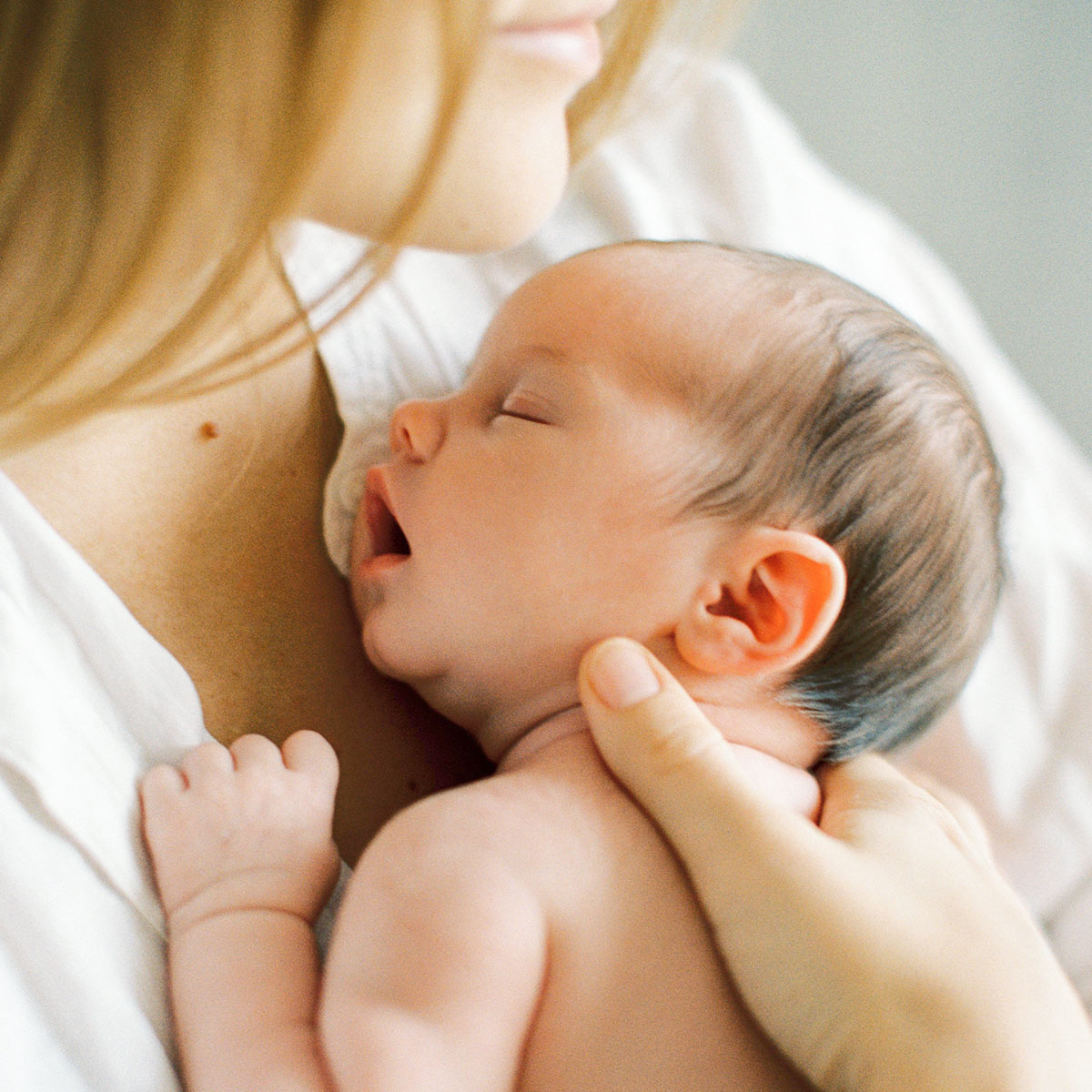 newborn baby girl sleeping in mother's hands
