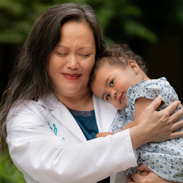 nemours doctor holding little girl