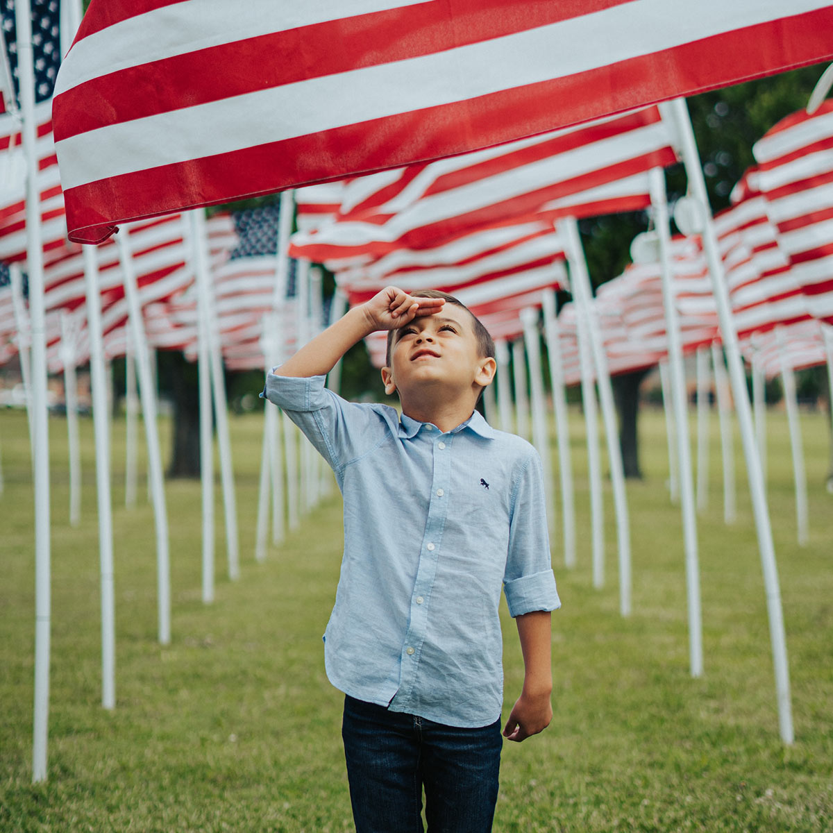 Boy saluting American Flag