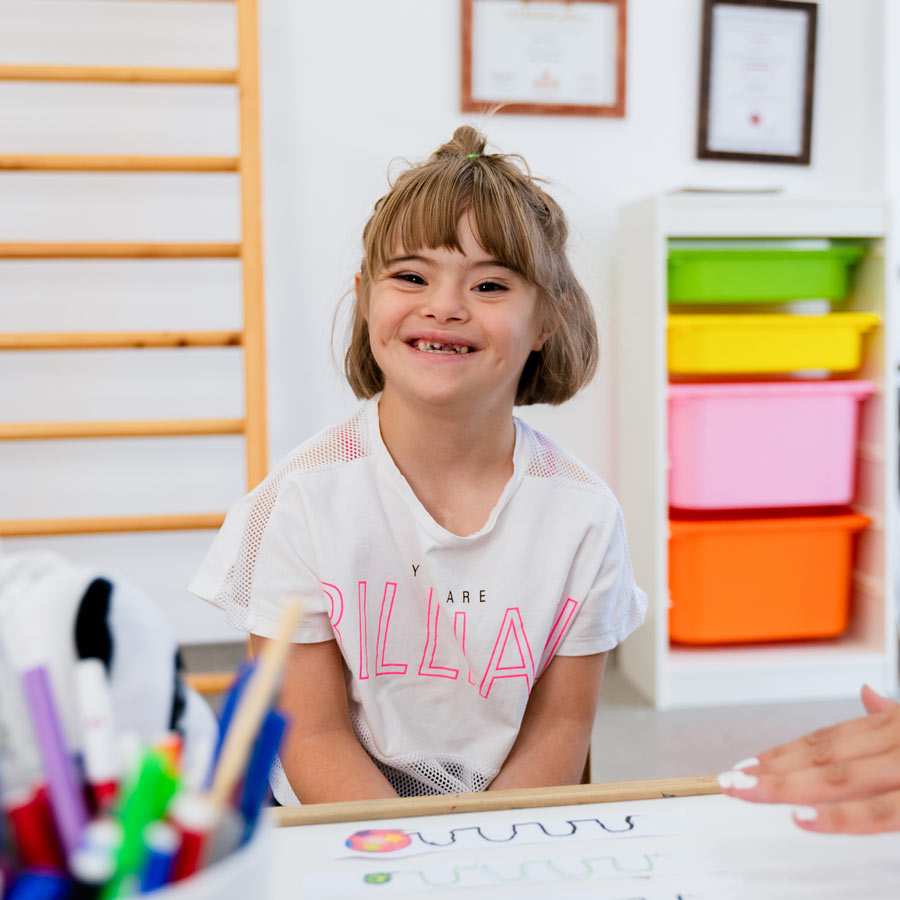 Girl smiling at art table