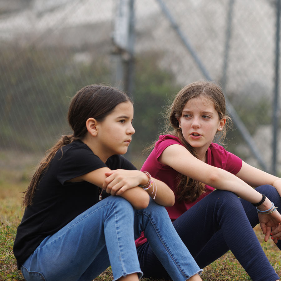 Two girls talking on playground