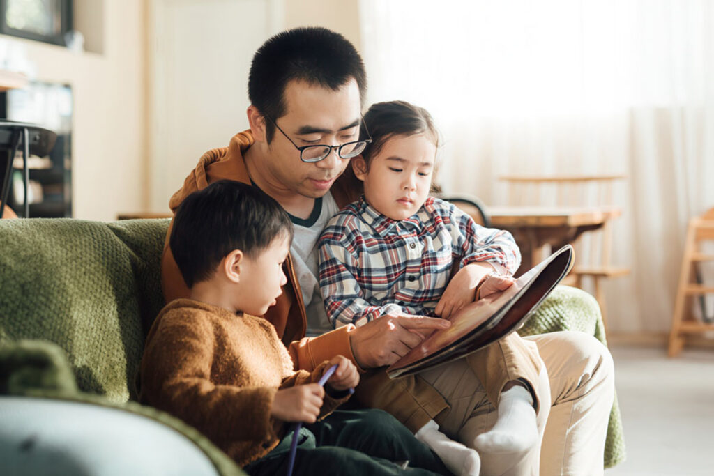 Dad reading to son and daughter