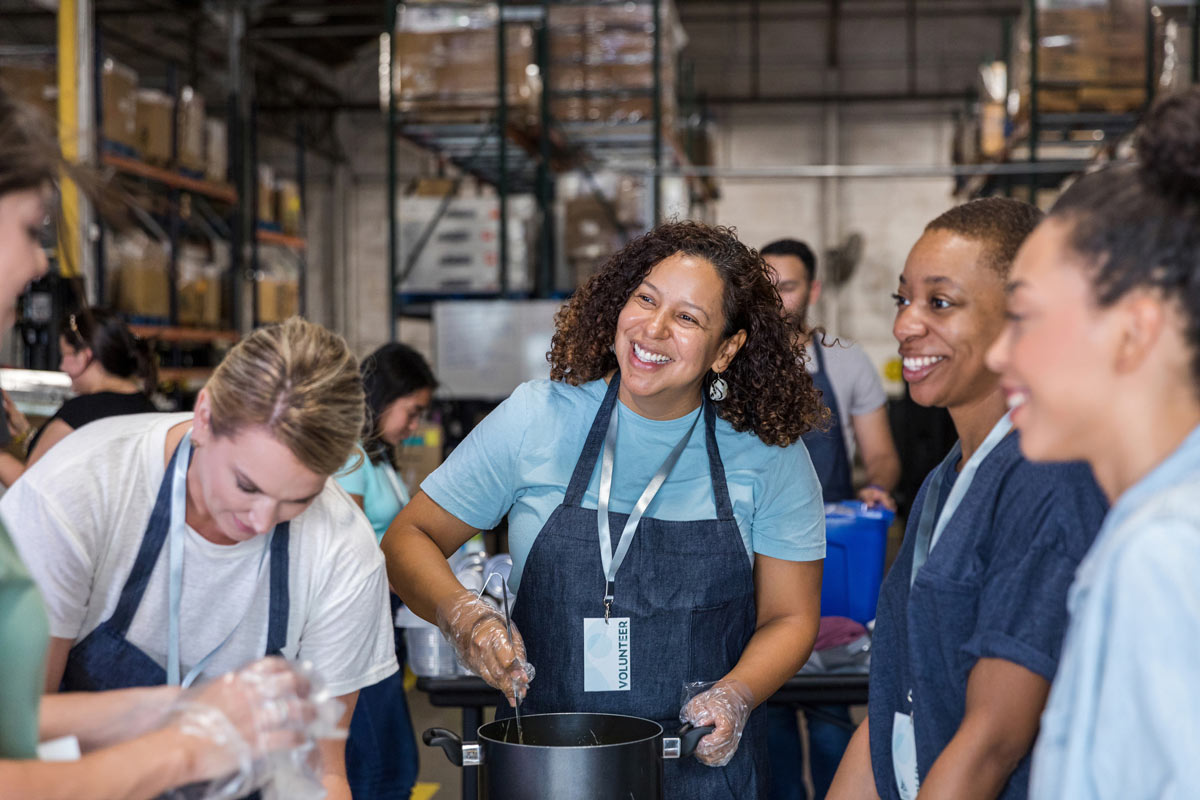 smiling volunteers at soup station