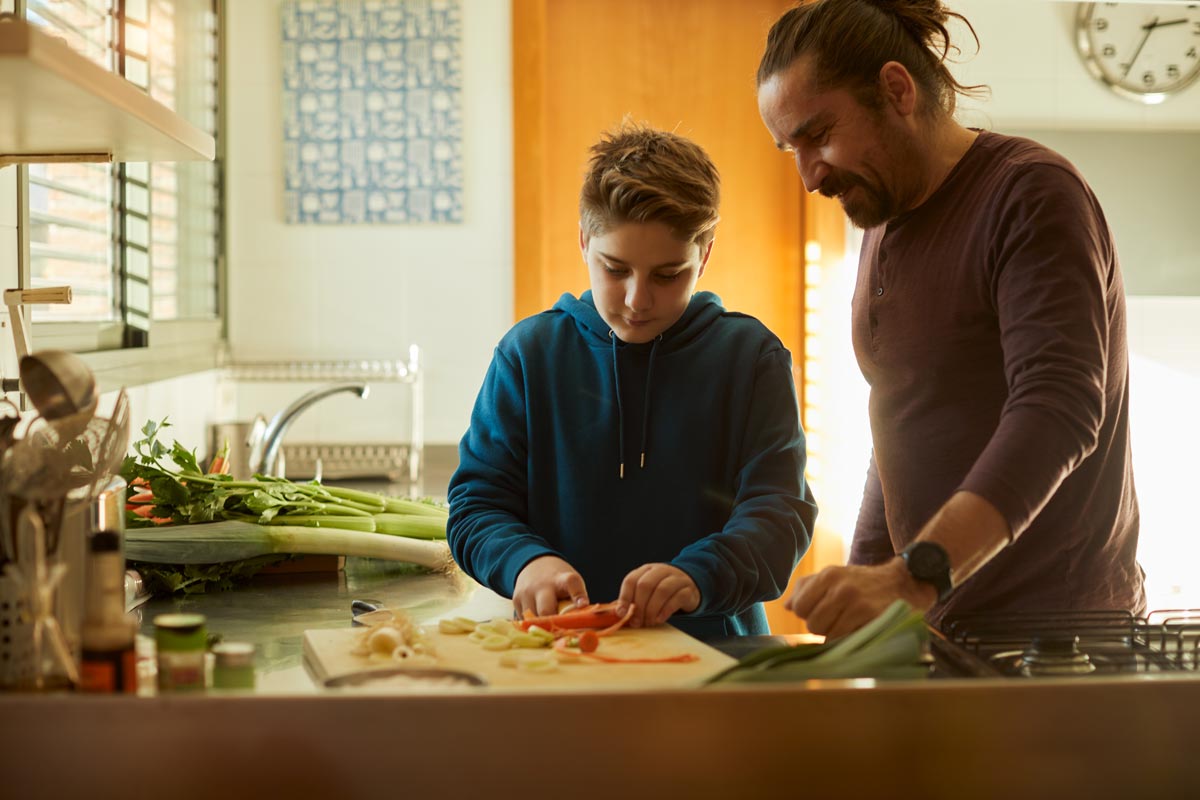 father and son cooking together
