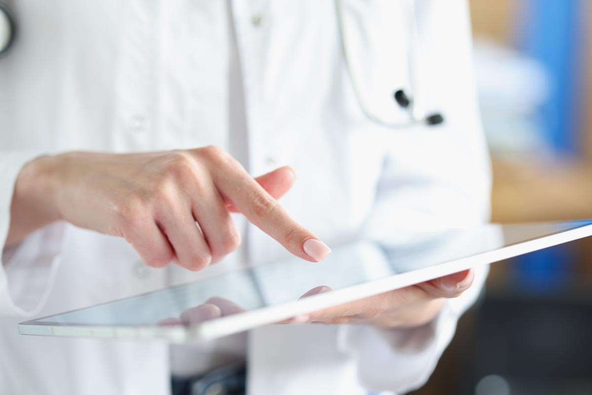 doctor points her finger at computer tablet