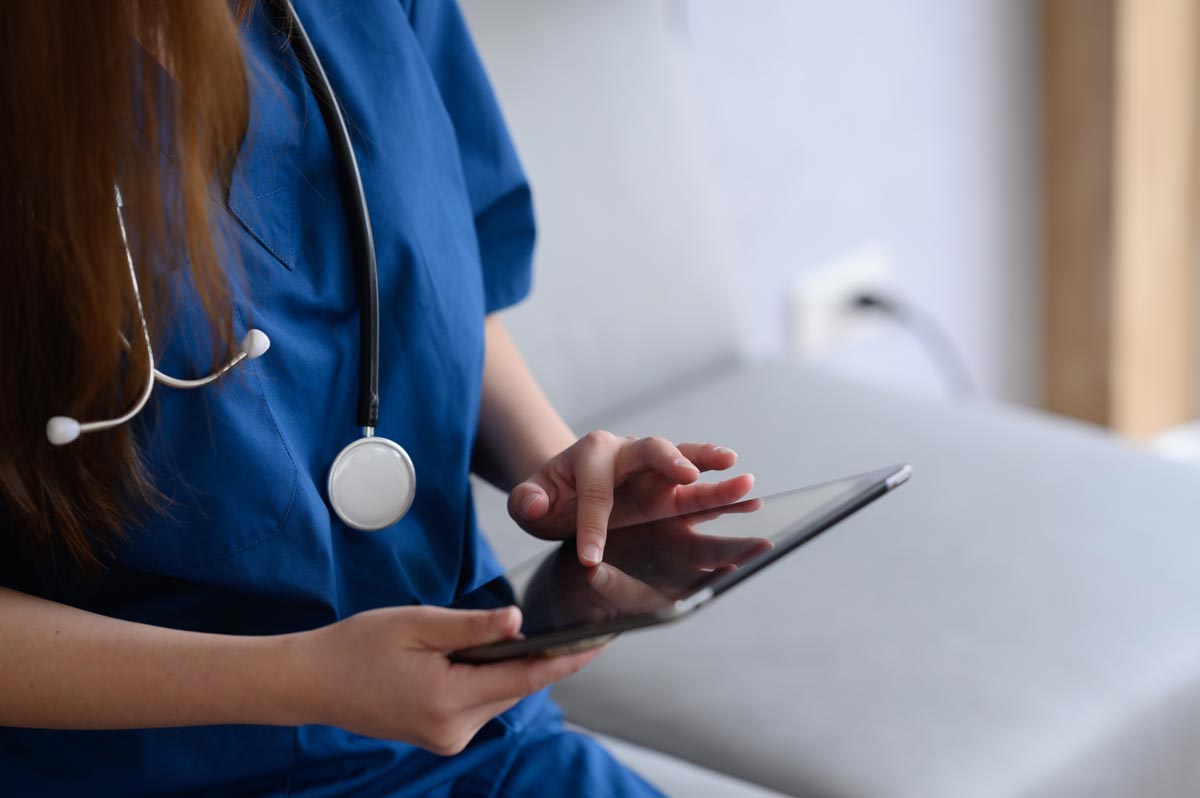 doctor's hand using computer tablet